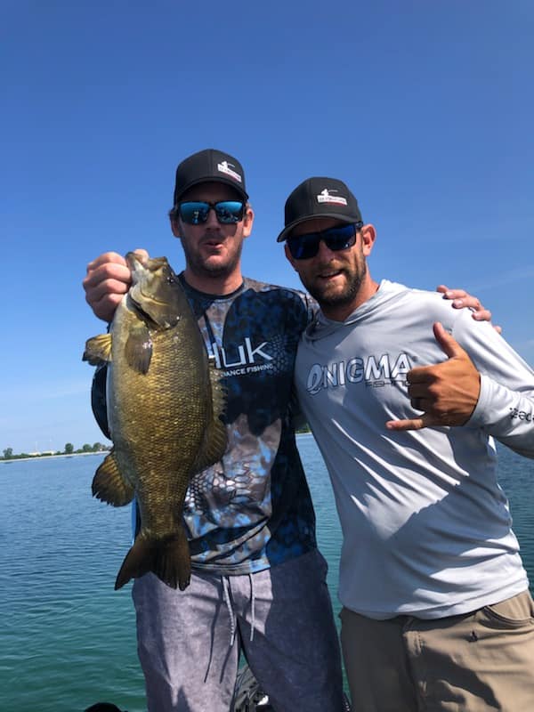 Two anglers celebrating a bass catch